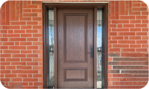 A dark wood-grain finish front door with two decorative recessed panels, flanked by two vertical glass sidelights with leaded glass patterns, installed in a red brick wall.