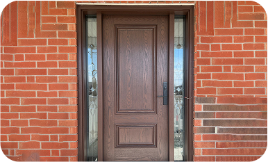 A dark wood-grain finish front door with two decorative recessed panels, flanked by two vertical glass sidelights with leaded glass patterns, installed in a red brick wall.