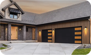 Exterior of a modern luxury home at dusk, featuring two black garage doors with horizontal frosted glass windows, warm outdoor lighting, and a matching wood-finish front door set against stone and wood siding.
