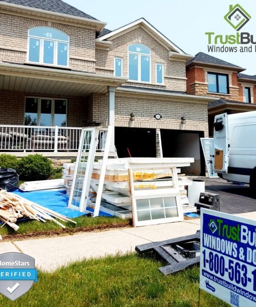 A before-and-after comparison of a basement window. The top shows a worn sliding window, while the bottom features a bright white, modern sliding unit installed in the brick wall.